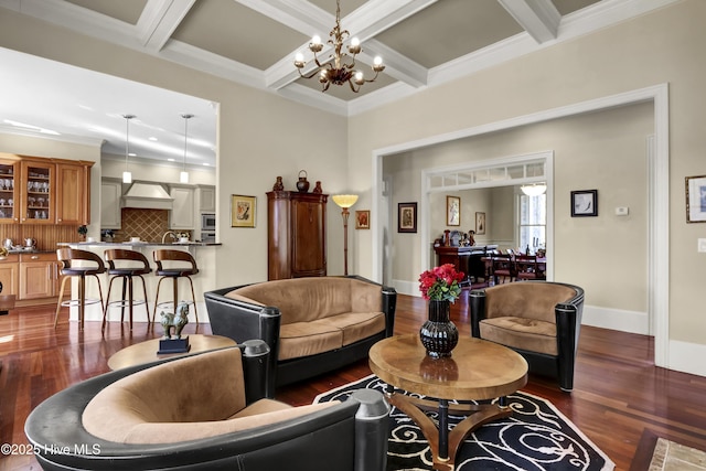 living room with dark wood finished floors, a chandelier, beamed ceiling, ornamental molding, and baseboards