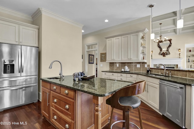 kitchen with stainless steel appliances, dark stone counters, a sink, and open shelves