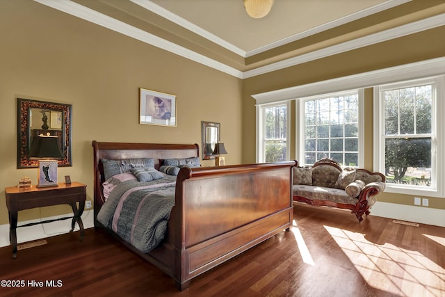 bedroom with visible vents, ornamental molding, and wood finished floors