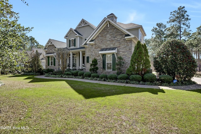 craftsman inspired home with stone siding and a front lawn