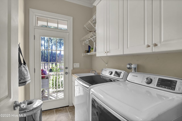 washroom featuring cabinet space, washer and clothes dryer, and ornamental molding