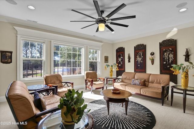 living area featuring light carpet, crown molding, visible vents, and ceiling fan