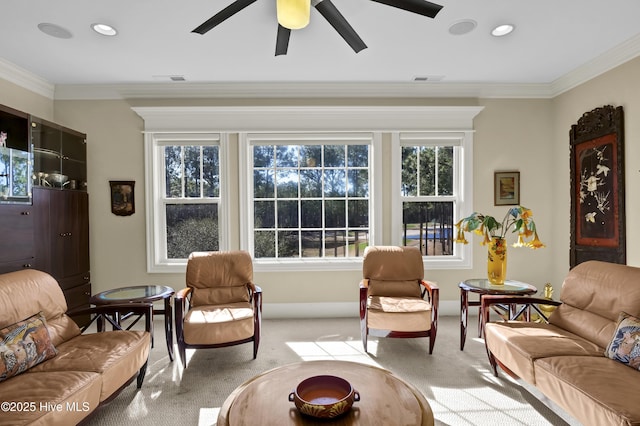 living area featuring ornamental molding, recessed lighting, a healthy amount of sunlight, and light carpet