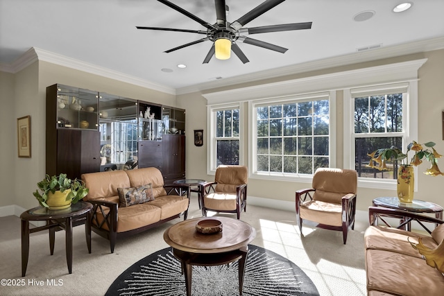 carpeted living room with ceiling fan, baseboards, crown molding, and recessed lighting