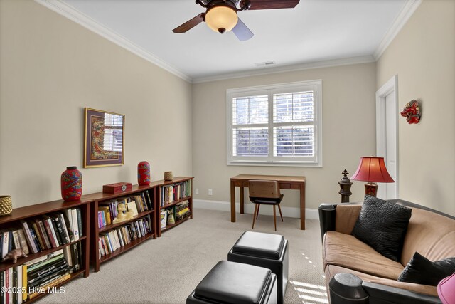 living area featuring ceiling fan, carpet flooring, crown molding, and baseboards