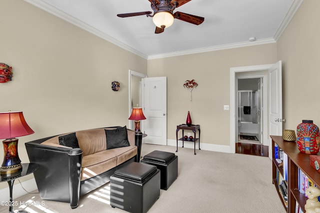 living area featuring a ceiling fan, carpet, baseboards, and crown molding