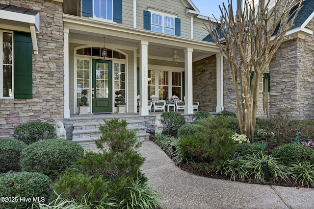 entrance to property with a porch and stone siding