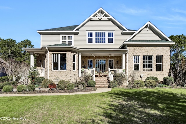 craftsman-style home with a porch, brick siding, a shingled roof, and a front lawn