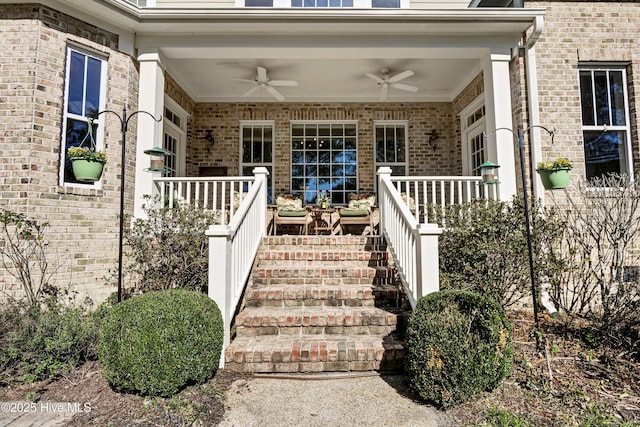 view of exterior entry featuring a ceiling fan and brick siding