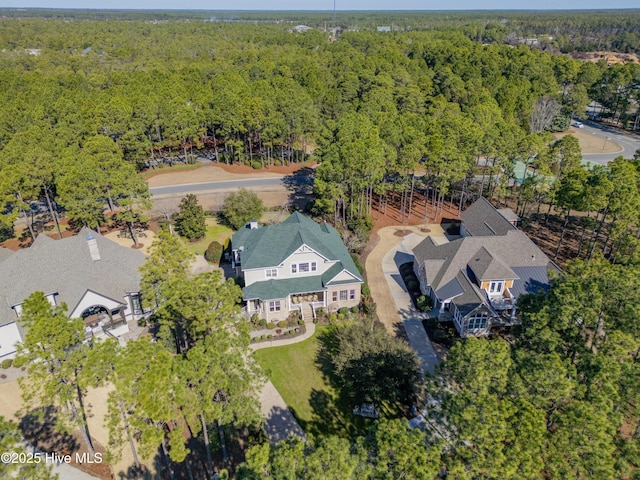 birds eye view of property with a view of trees