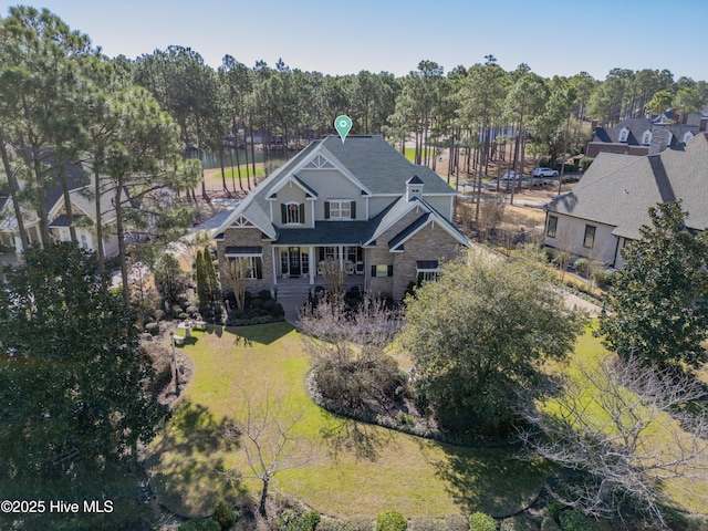 aerial view of property and surrounding area featuring a tree filled landscape