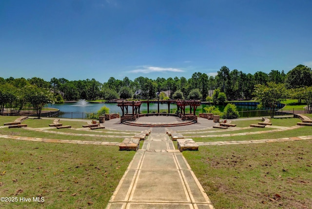 view of property's community featuring a water view and a lawn