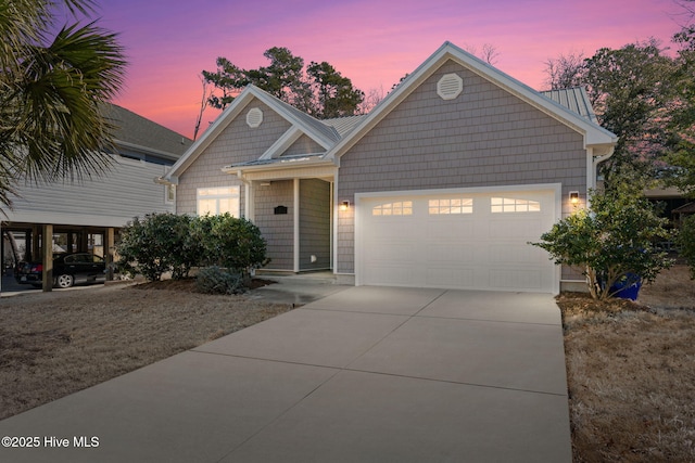 view of front of house with a garage, concrete driveway, and metal roof