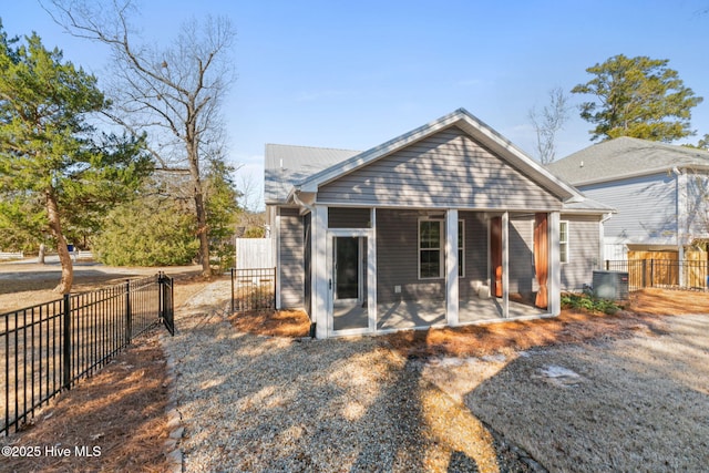 back of property featuring cooling unit and fence