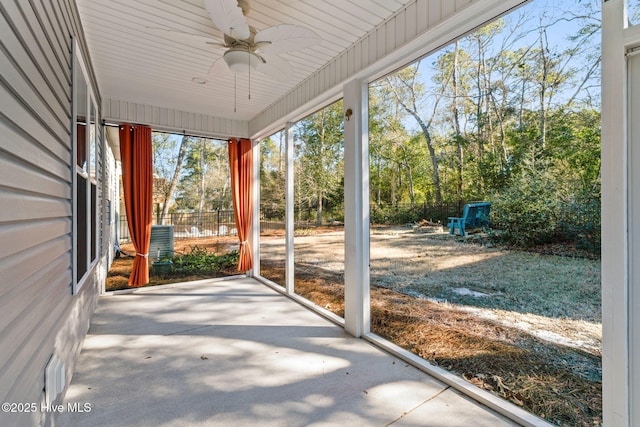 unfurnished sunroom with a ceiling fan