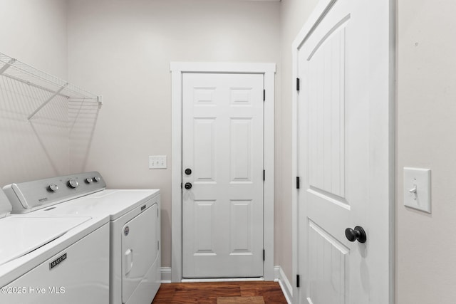 washroom with laundry area, baseboards, dark wood finished floors, and washer and dryer