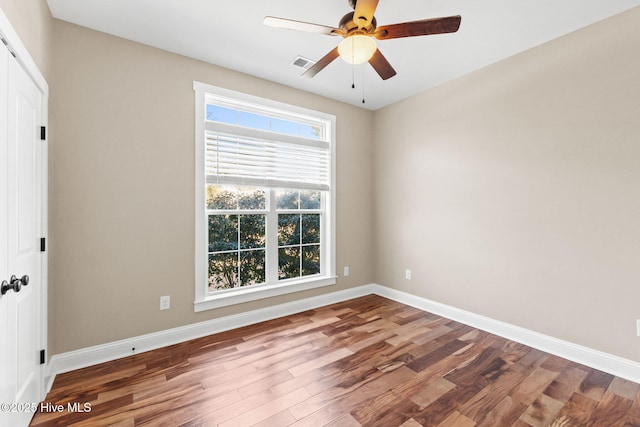 unfurnished room featuring a ceiling fan, baseboards, and wood finished floors