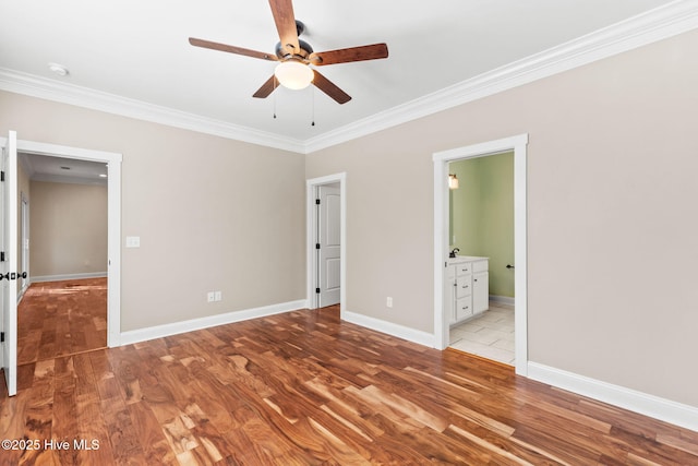 unfurnished bedroom featuring ornamental molding, light wood-style flooring, and baseboards