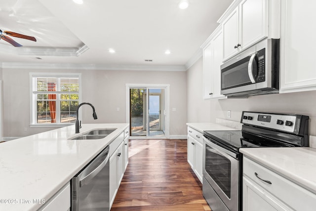 kitchen featuring ornamental molding, appliances with stainless steel finishes, a sink, and white cabinets