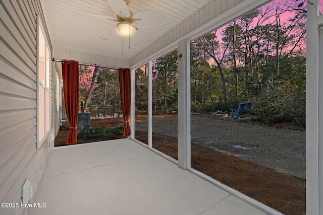 unfurnished sunroom with ceiling fan and a wealth of natural light