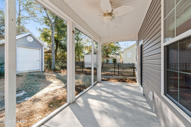 view of patio / terrace featuring a ceiling fan, an outbuilding, and fence