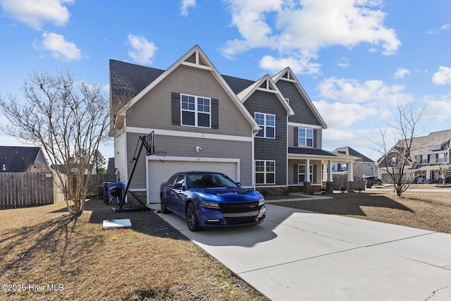 view of front of property featuring concrete driveway, a porch, an attached garage, and fence