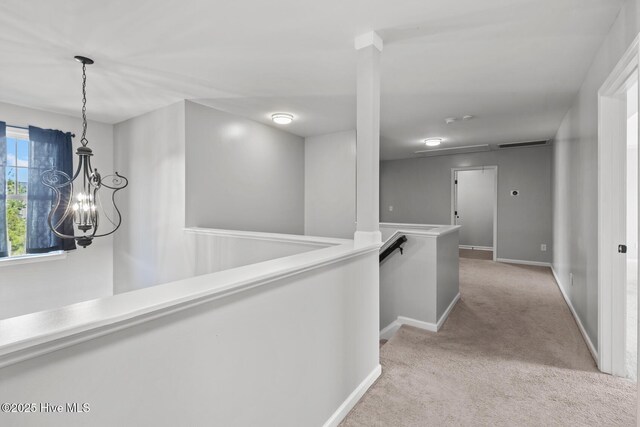 128 Pamlico Dr, Holly Ridge, NC 28445 - hall featuring visible vents, baseboards, light colored carpet, and an upstairs landing