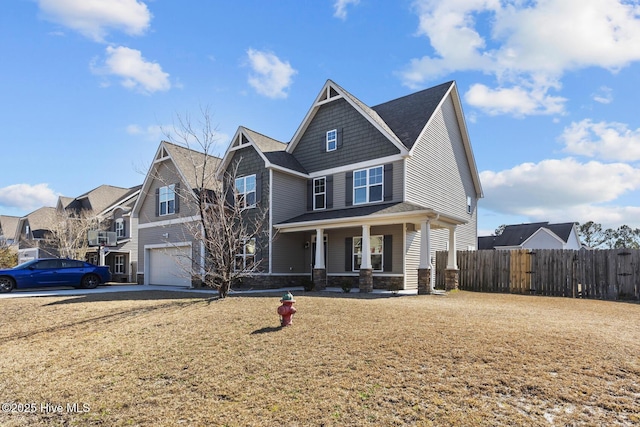 view of front of property with a garage, a porch, fence, and a residential view