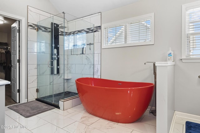 128 Pamlico Dr, Holly Ridge, NC 28445 - full bath featuring marble finish floor, a spacious closet, vaulted ceiling, a freestanding tub, and a shower stall