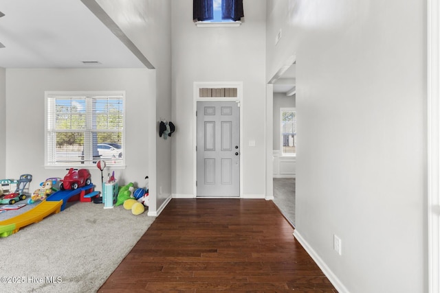 128 Pamlico Dr, Holly Ridge, NC 28445 - foyer entrance featuring a healthy amount of sunlight, visible vents, baseboards, and wood finished floors