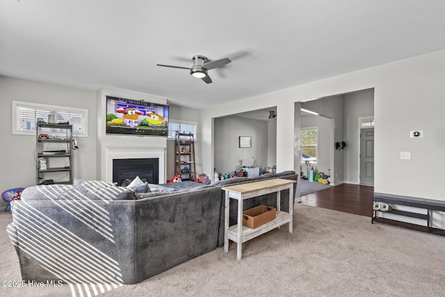 128 Pamlico Dr, Holly Ridge, NC 28445 - living area with ceiling fan, a fireplace, a wealth of natural light, and carpet
