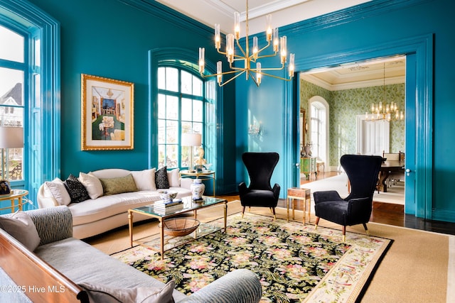 sitting room featuring crown molding, wallpapered walls, wood finished floors, and an inviting chandelier