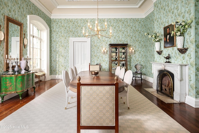 dining space featuring crown molding, dark wood finished floors, and wallpapered walls