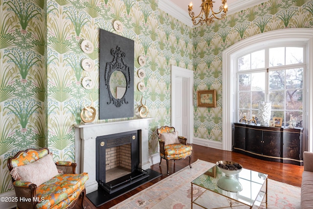 sitting room featuring baseboards, a fireplace, dark wood finished floors, and wallpapered walls