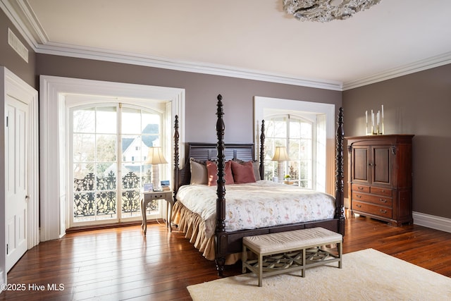 bedroom featuring ornamental molding, dark wood-style flooring, and visible vents