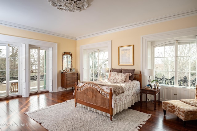 bedroom featuring access to exterior, crown molding, and wood finished floors