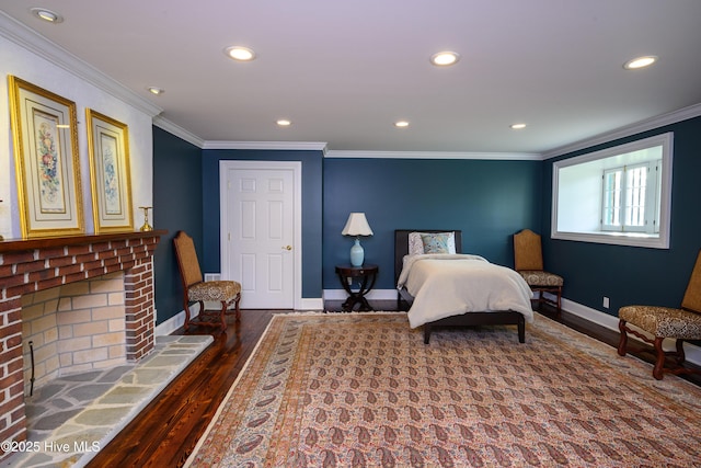 bedroom with a fireplace, recessed lighting, ornamental molding, wood finished floors, and baseboards