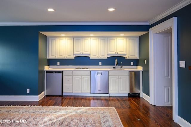 kitchen with a sink, crown molding, light countertops, and dishwasher