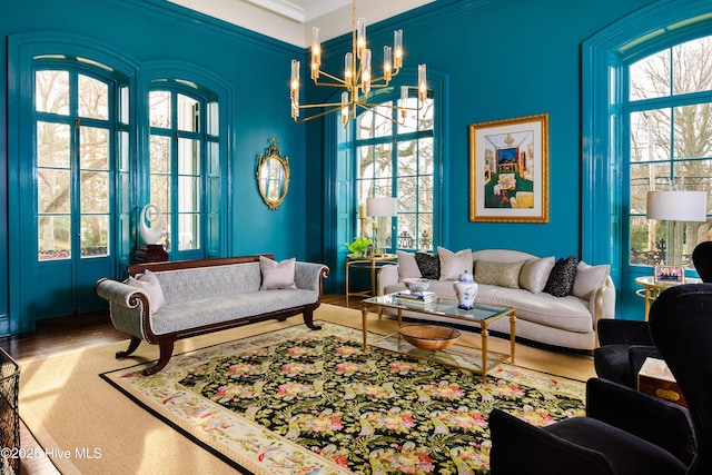 interior space featuring a wealth of natural light, a notable chandelier, and wood finished floors