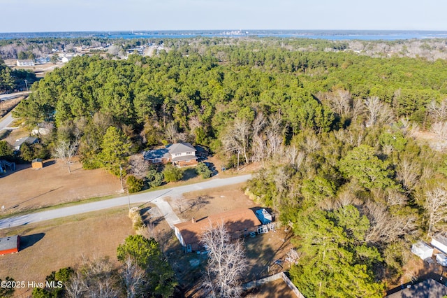 birds eye view of property featuring a wooded view