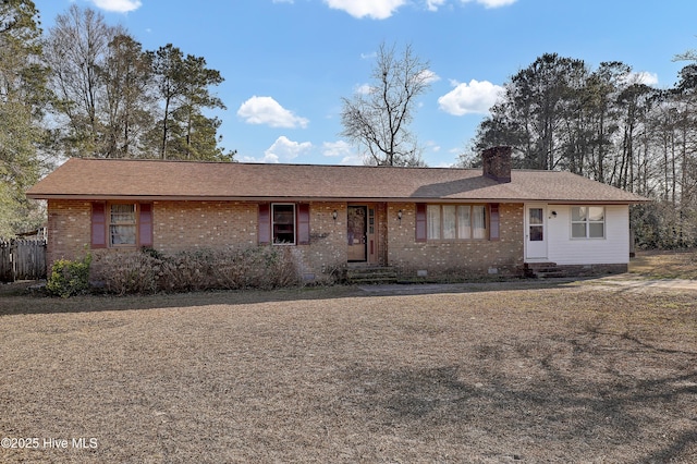 ranch-style home featuring entry steps, crawl space, brick siding, and a chimney