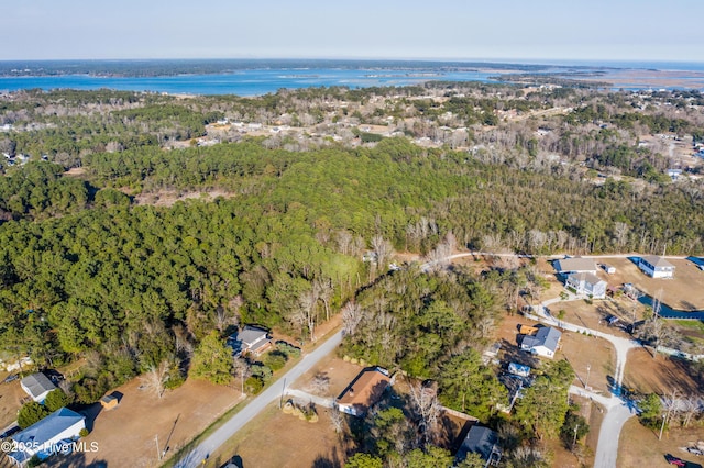 drone / aerial view with a wooded view