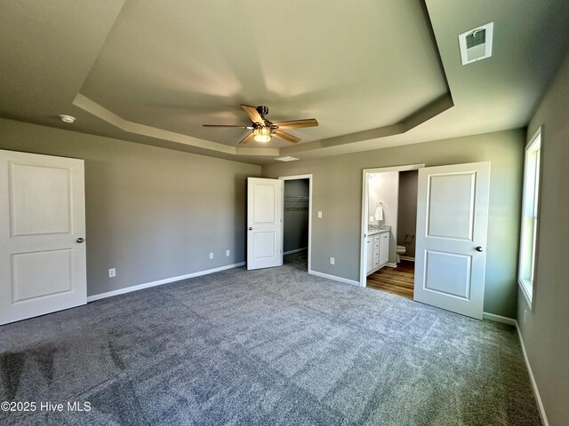 bathroom with a garden tub, wood finished floors, a stall shower, and baseboards