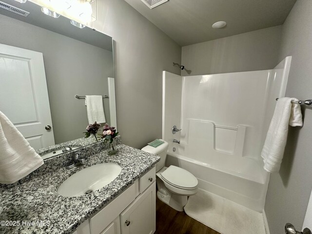 spare room with dark colored carpet, visible vents, and baseboards