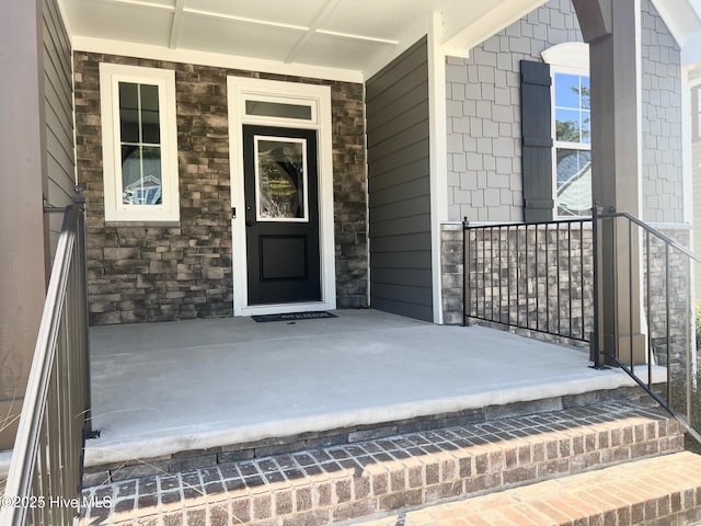 view of exterior entry featuring stone siding