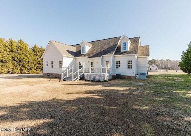 rear view of property with crawl space, a lawn, and central air condition unit