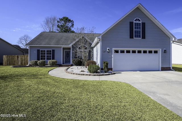 view of front facade with a garage, driveway, a front yard, and fence