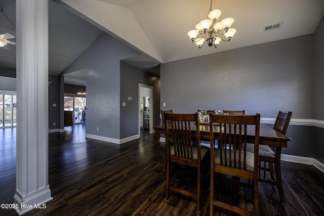 dining space with visible vents, dark wood-type flooring, vaulted ceiling, baseboards, and ceiling fan with notable chandelier