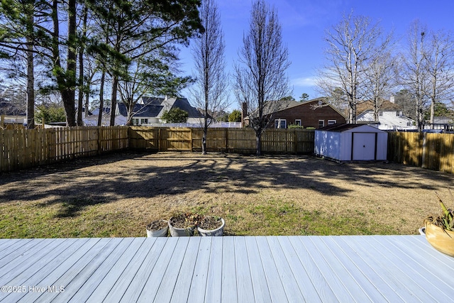 view of yard featuring an outbuilding, a fenced backyard, and a shed