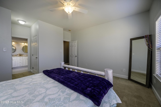 bedroom with carpet, ceiling fan, baseboards, and ensuite bathroom